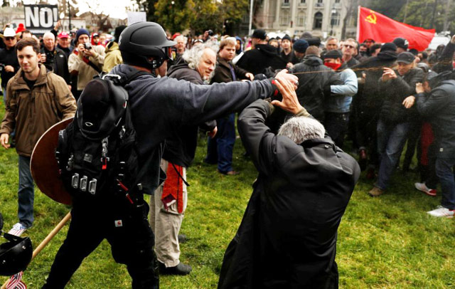 Chapman attacking protesters with pepper spray.